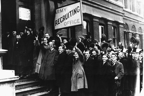 Volunteers queue to enlist outside a recruiting office in 1914