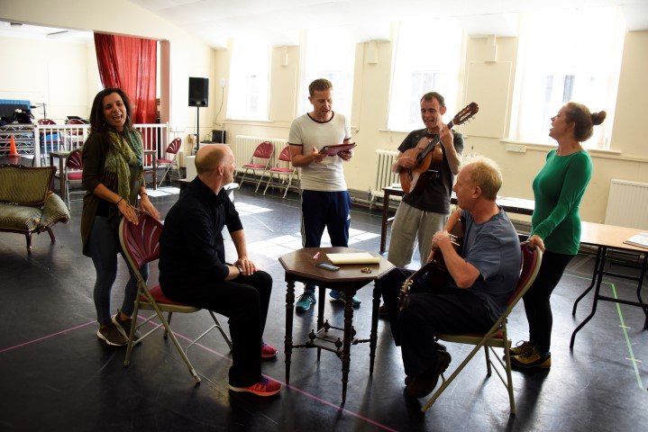 The cast and director Conrad Nelson in They Don't Pay? We Won't Pay! rehearsals. Photograph by Nobby Clark.